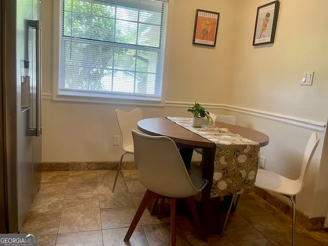 a view of a dining room with furniture and window