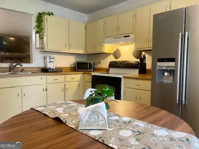 a kitchen with a sink appliances and cabinets