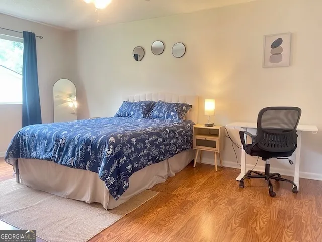 a bedroom with a bed chair and a window