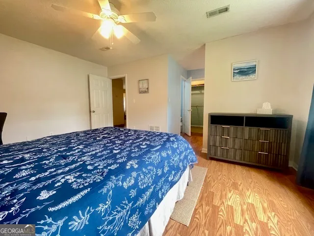 a spacious bedroom with a bed and a cabinets