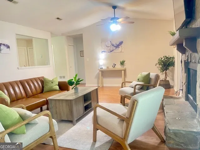 a living room with furniture a chandelier and a dining room