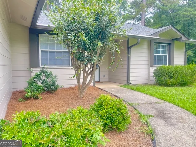 a front view of a house with garden