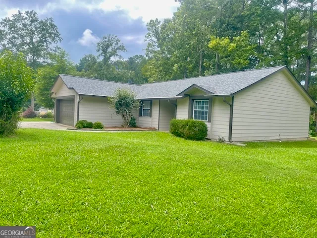 a front view of house with yard and green space