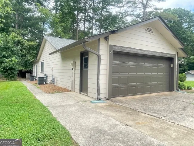 a view of backyard of house and garage