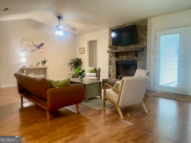 a living room with furniture a fireplace and a flat screen tv