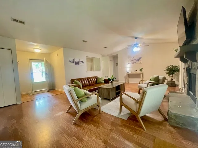 a living room with furniture and a flat screen tv