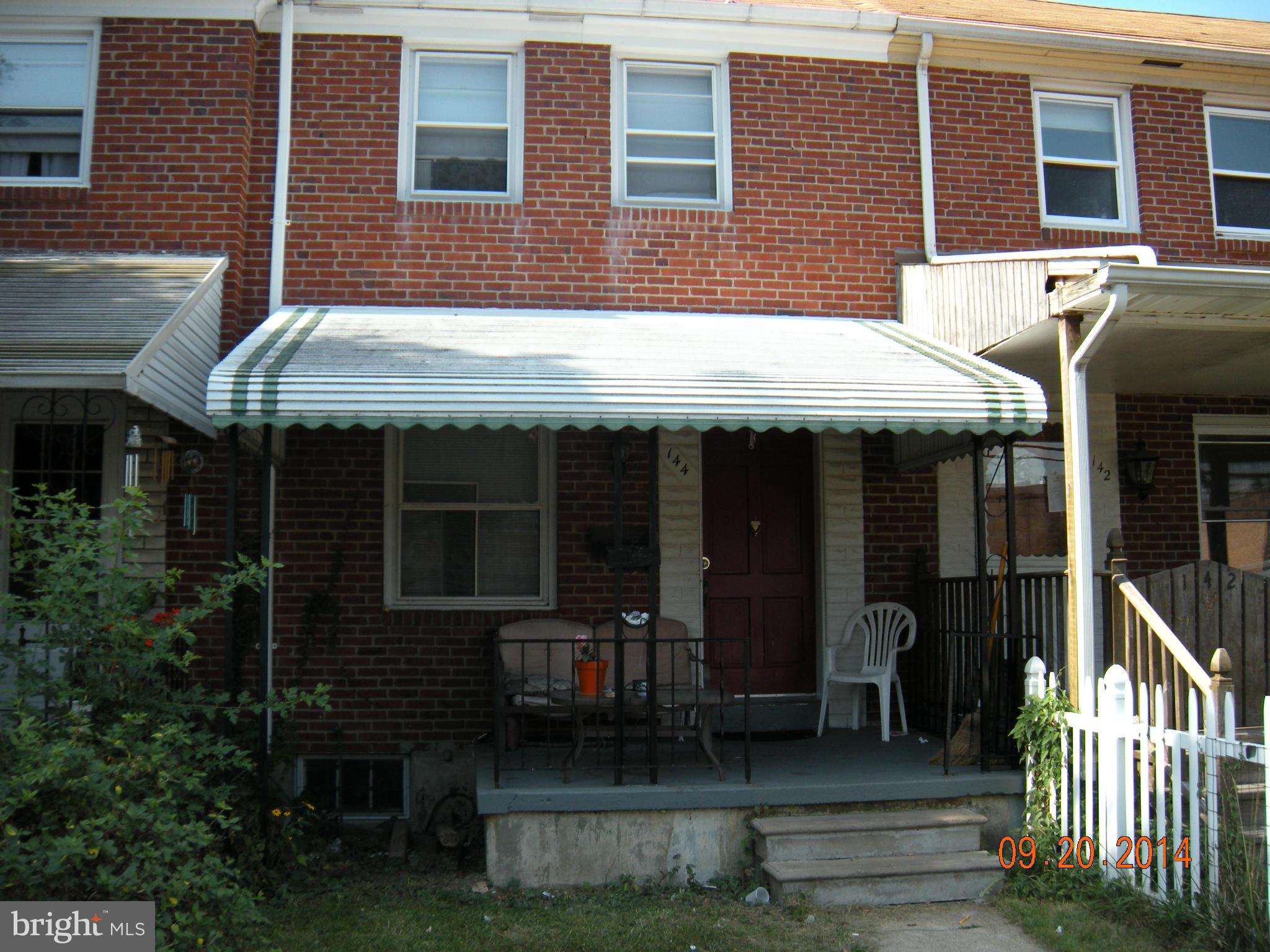 a view of brick house with large windows and a table
