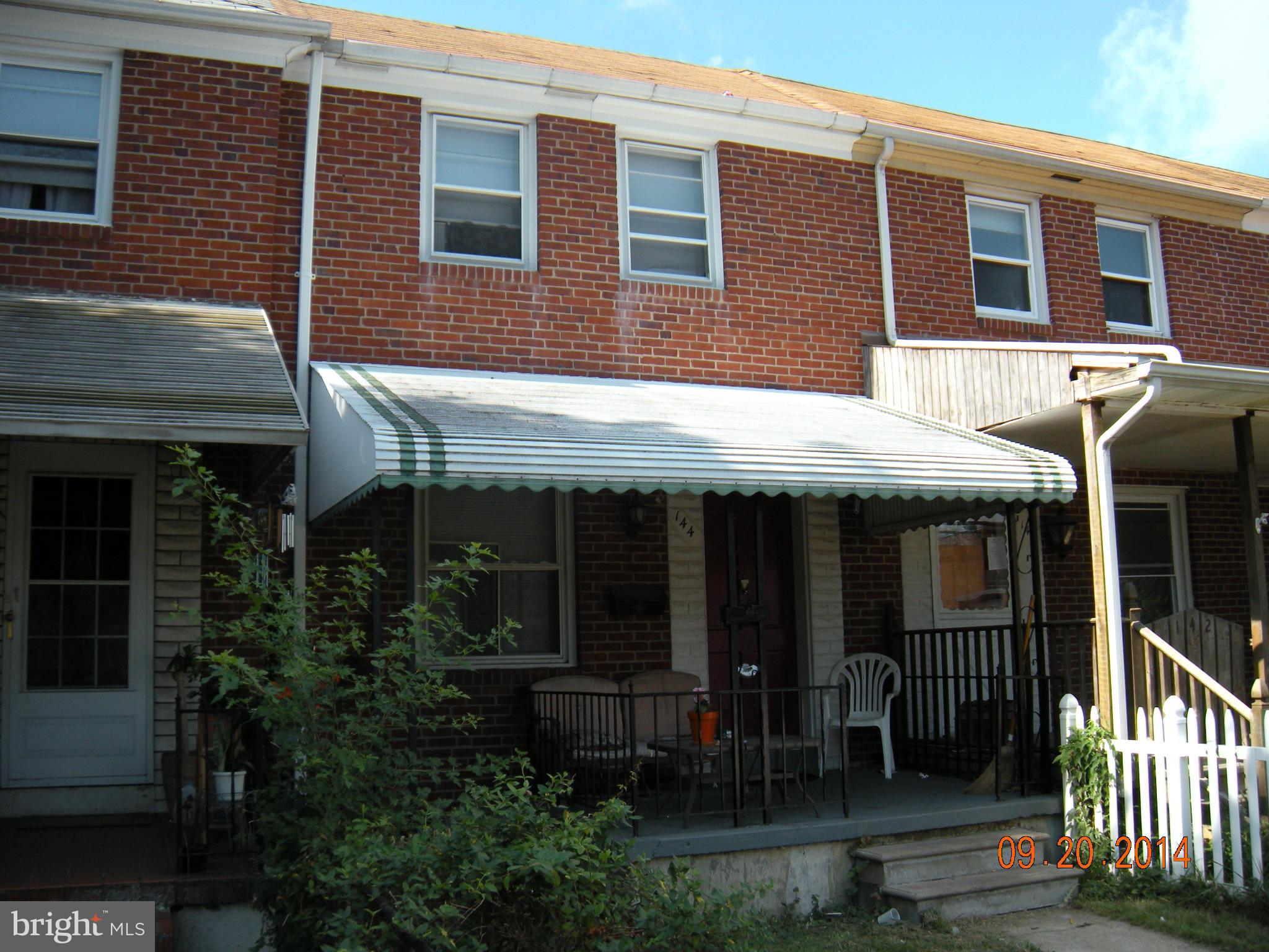 144 Kingston Road Middle River, MD 21220 - Photo 2 of 13 a view of brick house with large windows and plants