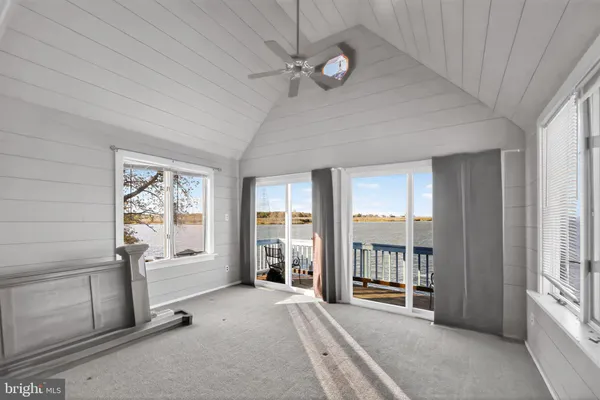 a view of an empty room with window and cabinet