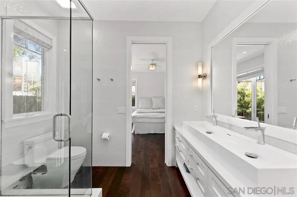 139 27th Street Del Mar, CA 92014 - Photo 15 of 25 a bathroom with a double vanity sink a mirror and a shower