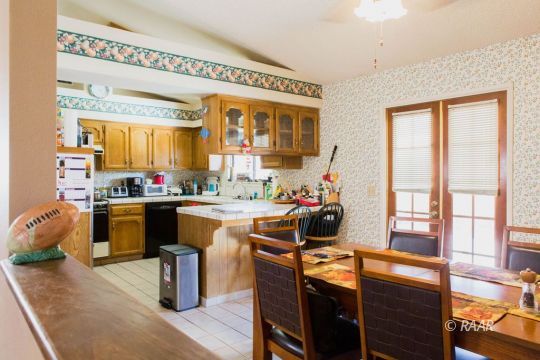 204 North Broadway Street Ridgecrest, CA 93555 - Photo 9 of 29 a dining room with furniture a window and kitchen view