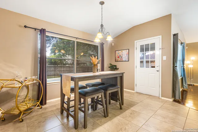 a dining room with furniture and window