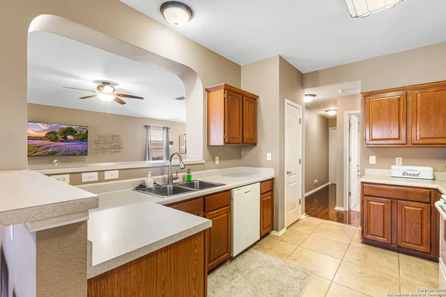 a kitchen with a sink a stove and cabinets
