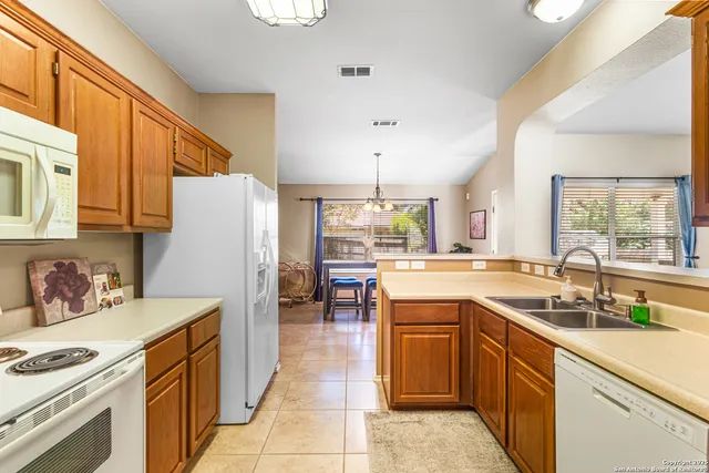 a kitchen with a sink stove and refrigerator