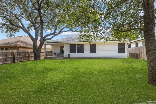 a view of a house with a backyard