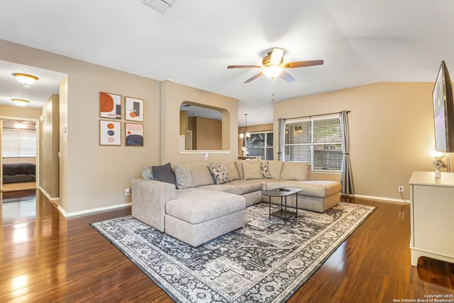 a living room with furniture and wooden floor