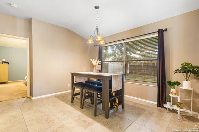 a dining room with furniture and window