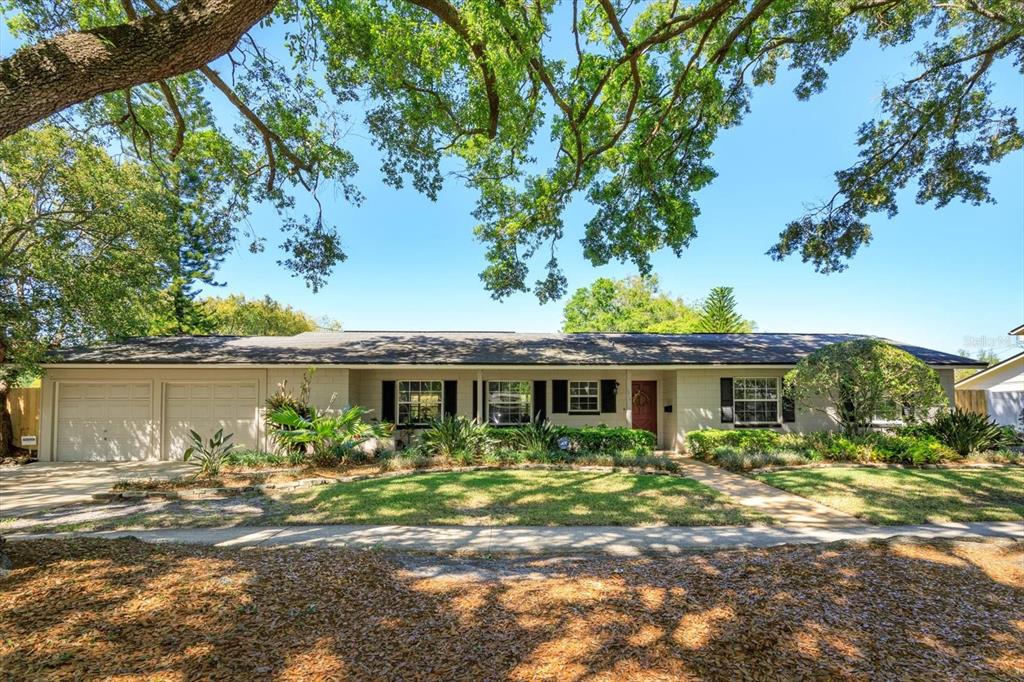 2819 Scarlet Road Winter Park, FL 32792 - Photo 1 of 1 a front view of a house with a yard and potted plants