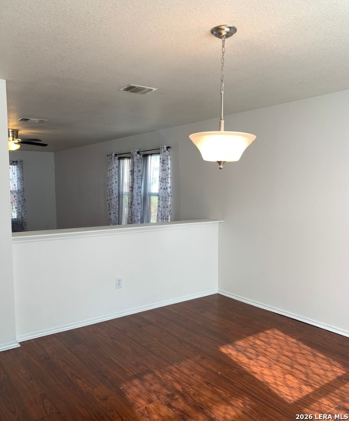 9818 Copper Elm Converse, TX 78109 - Photo 5 of 11 a view of a room with a chandelier fan and wooden floor