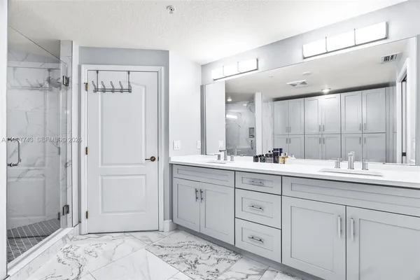 a bathroom with a double vanity sink and a mirror