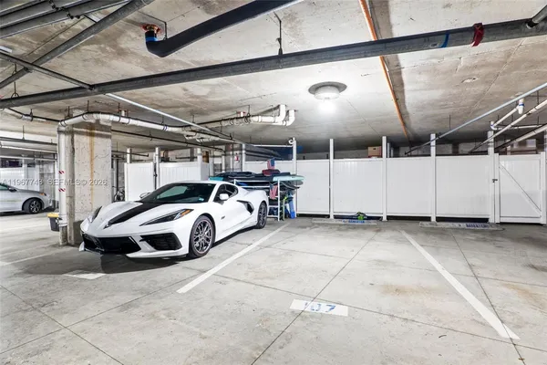 a view of parking garage with cars