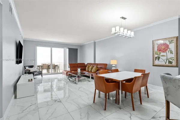 a view of a dining room with furniture a chandelier and a window