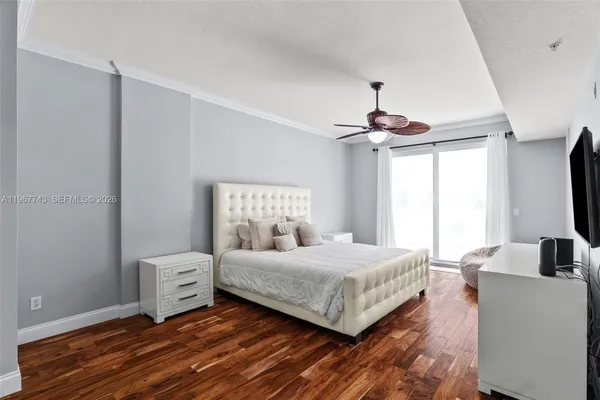 a bedroom with a bed and a chandelier