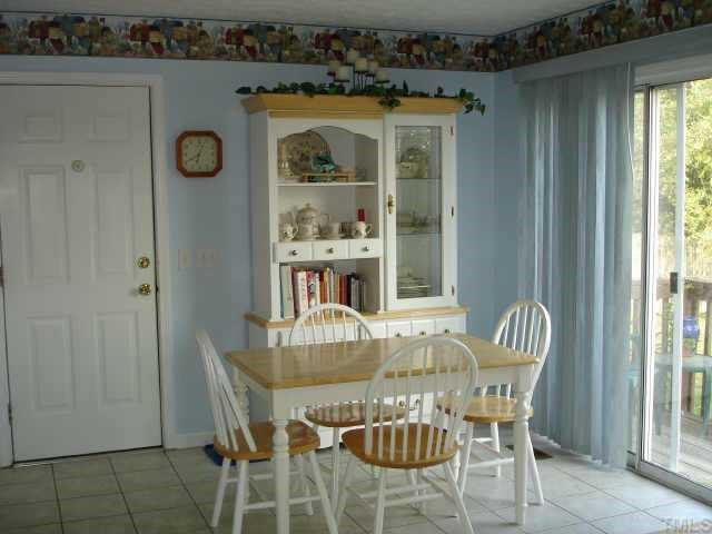 1207 Lexington Farm Road Apex, NC 27502 - Photo 4 of 10 Lots of outside light brightens up your meals in this breakfast area that features ceramic tile floors and a nice view of the backyard. Other