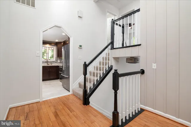 a view of entryway and hall with wooden floor