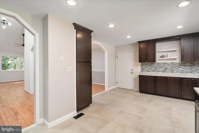 a large bathroom with a granite countertop sink a mirror and a shower