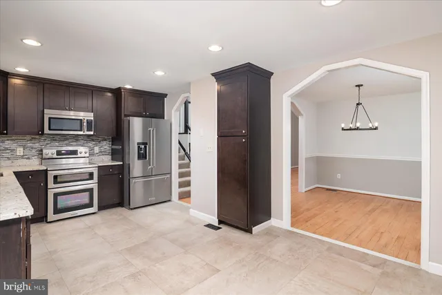 a view of kitchen with refrigerator and microwave