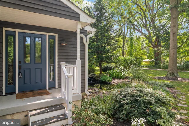 a backyard of a house with plants and outdoor seating