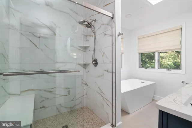 a bathroom with a bathtub and shower