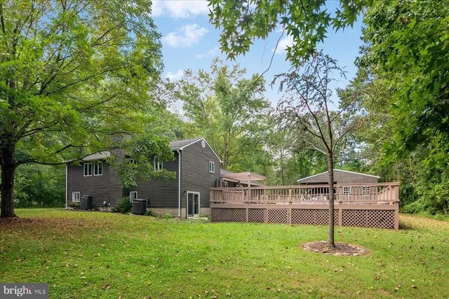 a house is sitting in middle od the grass