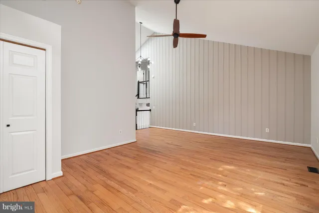 a view of empty room with wooden floor