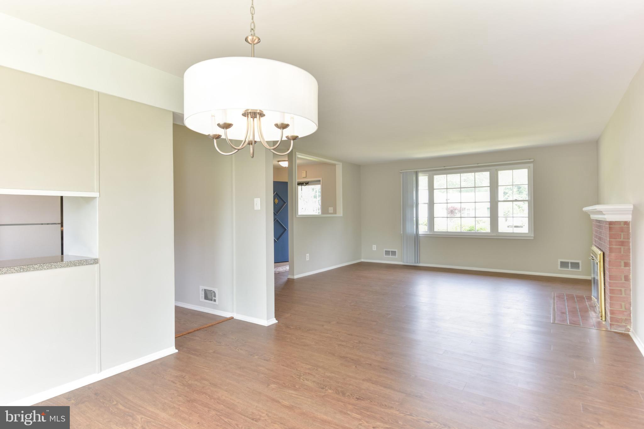8021 Ellet Road Springfield, VA 22151 - Photo 11 of 53 an empty room with wooden floor mirror and windows