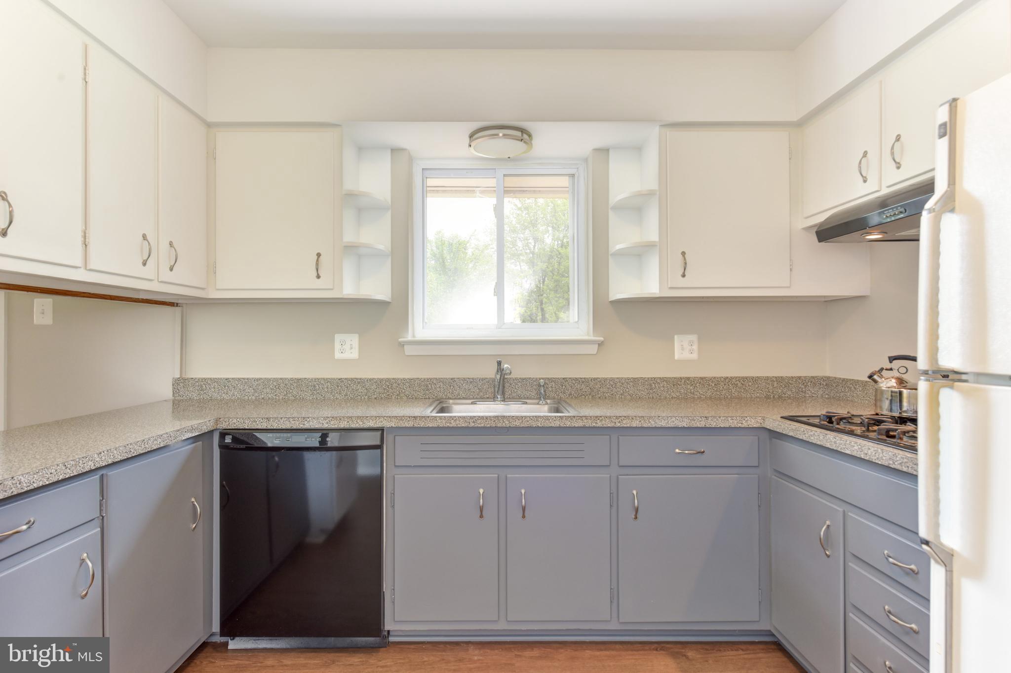 8021 Ellet Road Springfield, VA 22151 - Photo 13 of 53 a kitchen with cabinets appliances a sink and a window