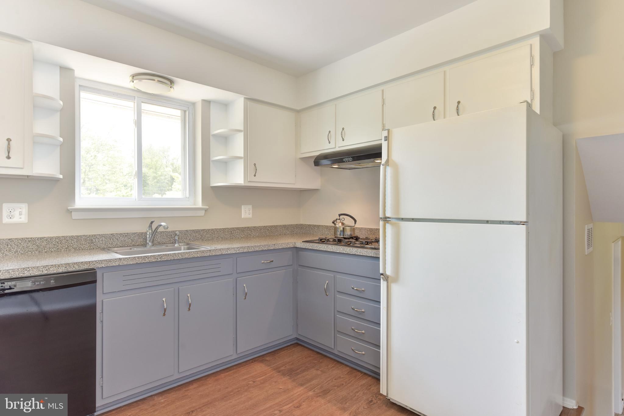 8021 Ellet Road Springfield, VA 22151 - Photo 14 of 53 a kitchen with a sink a refrigerator a window and cabinets