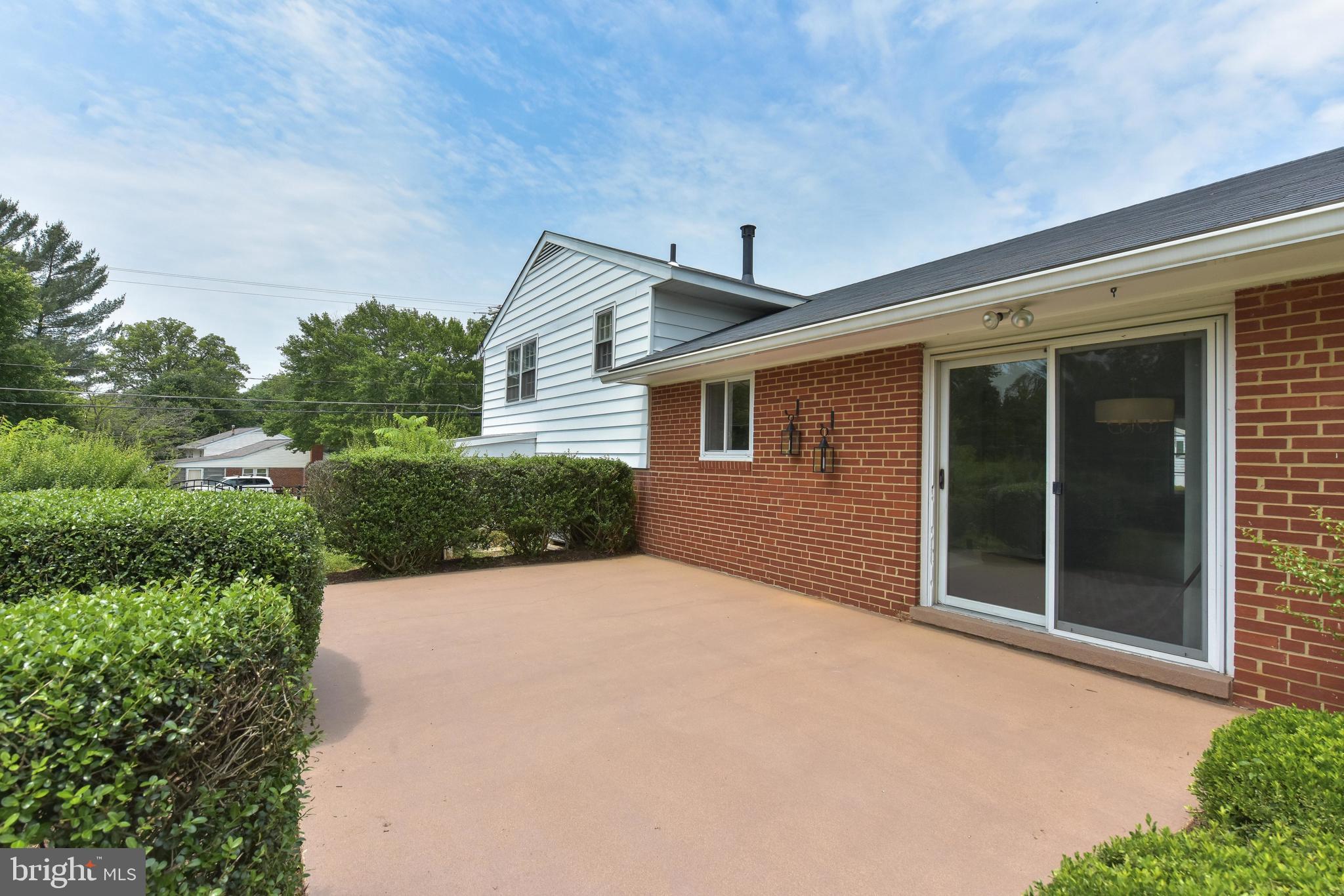8021 Ellet Road Springfield, VA 22151 - Photo 38 of 53 a view of a house with a yard and potted plants