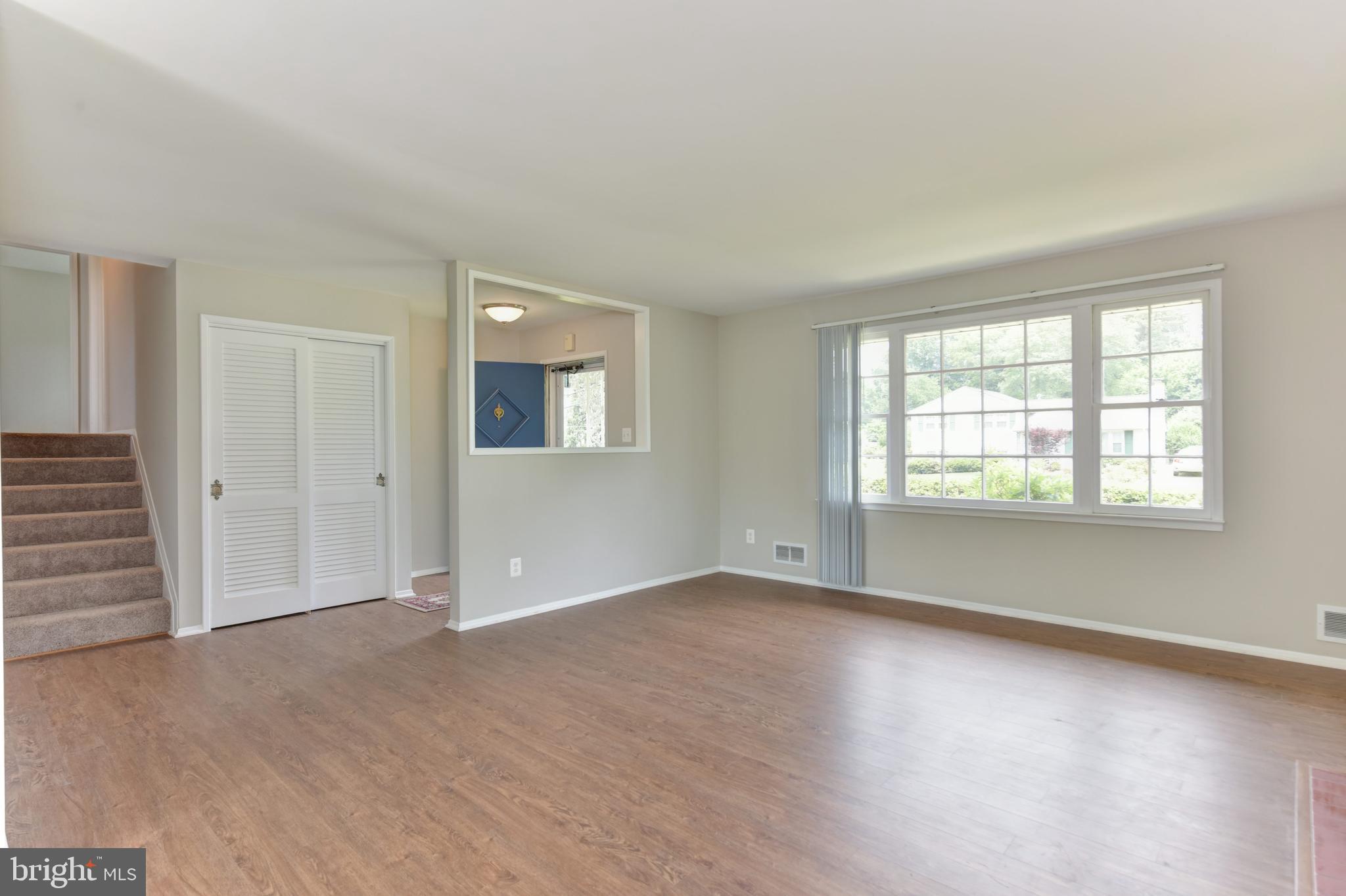 8021 Ellet Road Springfield, VA 22151 - Photo 5 of 53 an empty room with wooden floor and windows