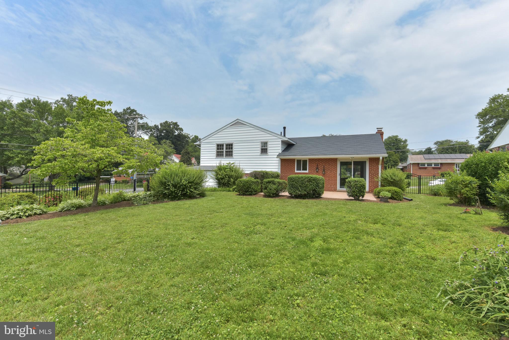 8021 Ellet Road Springfield, VA 22151 - Photo 45 of 53 a front view of a house with a yard and trees