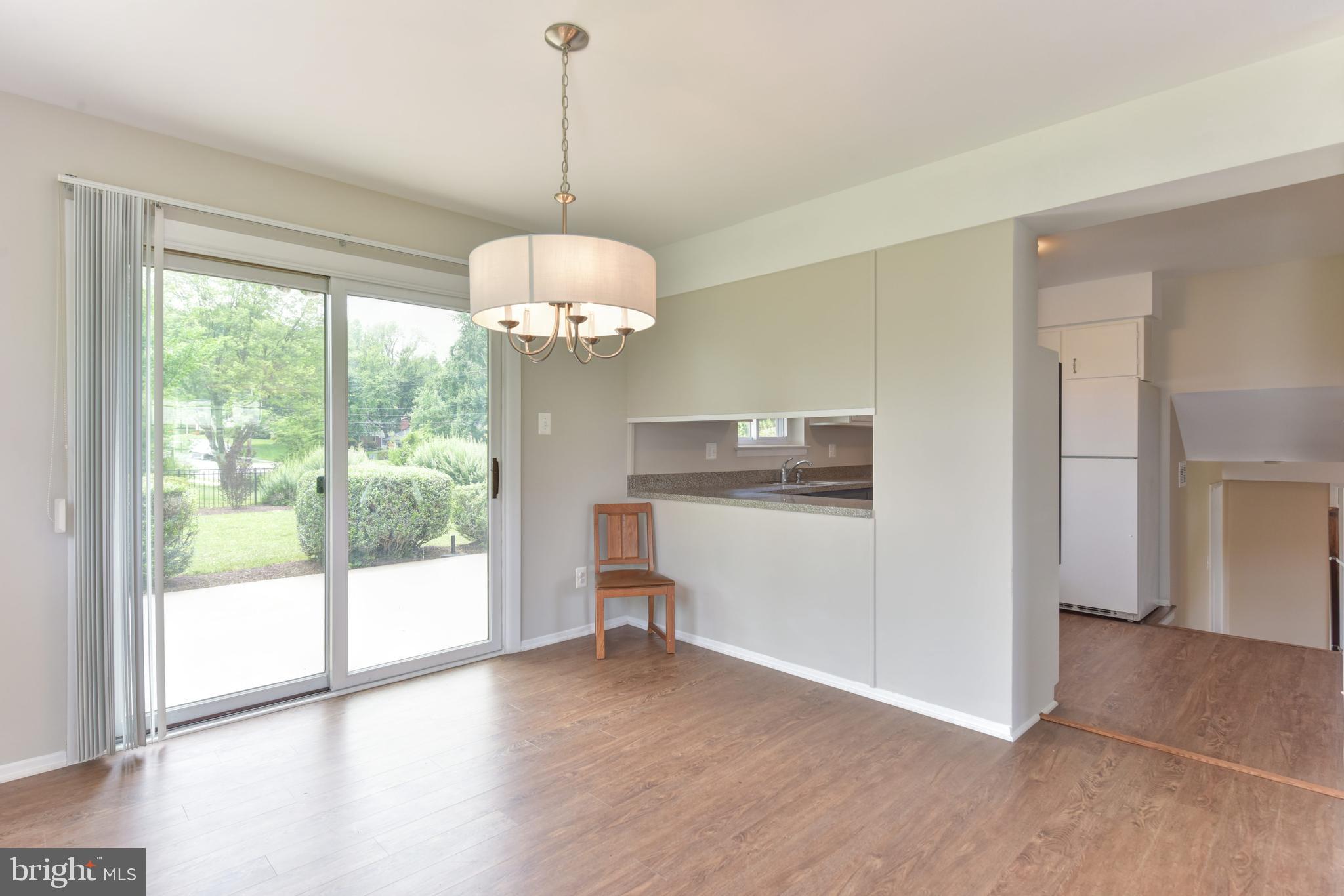 8021 Ellet Road Springfield, VA 22151 - Photo 10 of 53 a view of a room with wooden floor chandeliers and kitchen view