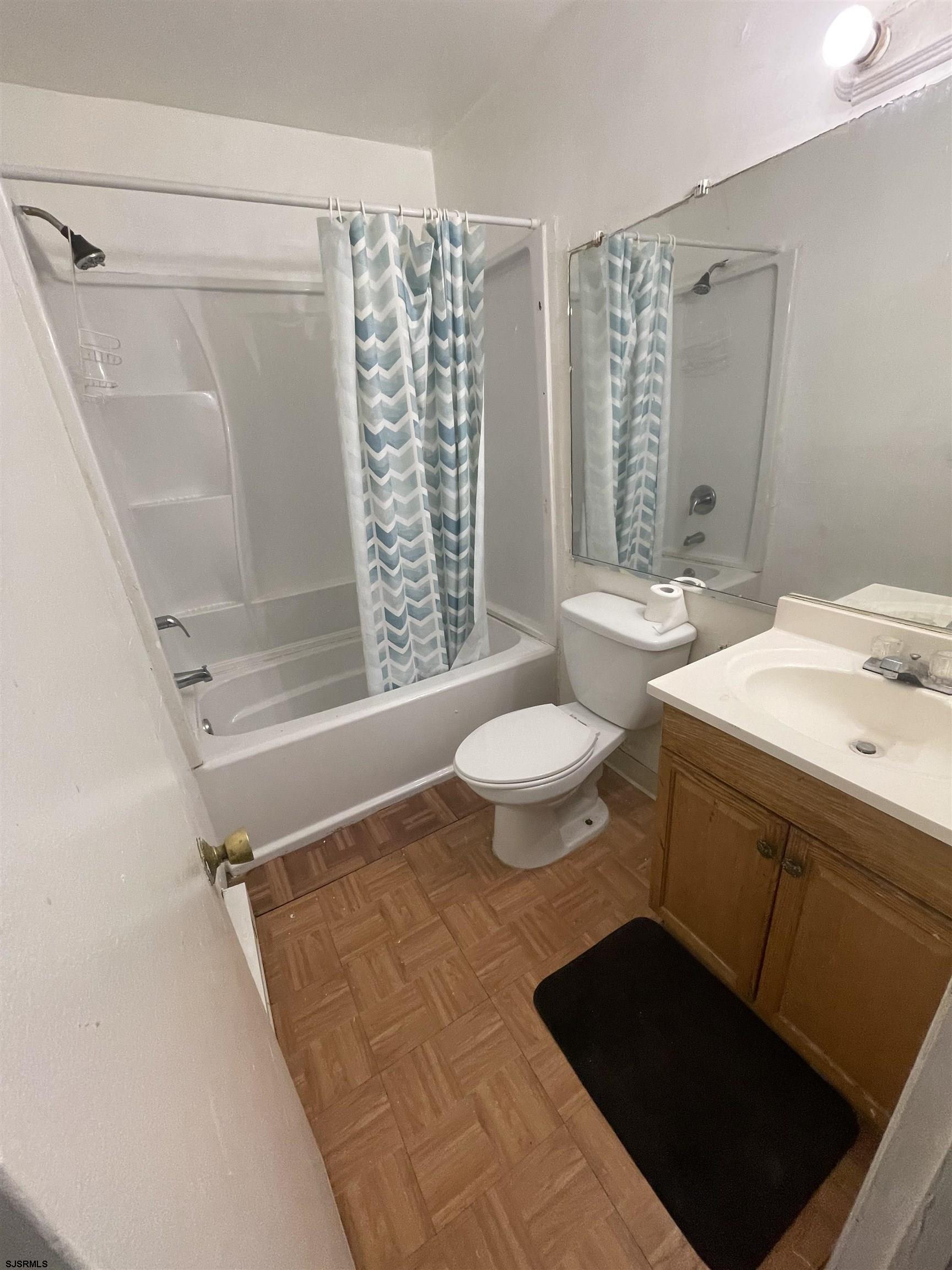 720 South New Road, Unit 5E Absecon, NJ 08201 - Photo 6 of 8 a bathroom with a sink toilet a mirror and shower