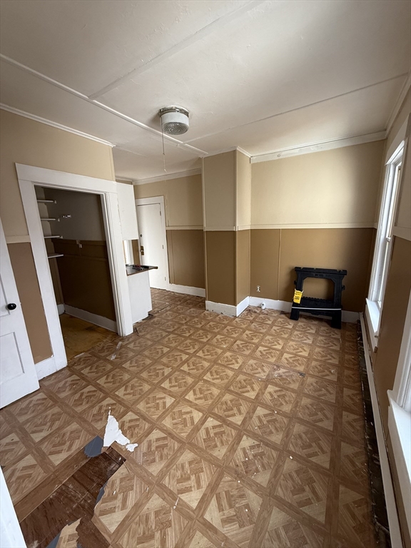 74 Bacon Street, Unit 2 Orange, MA 01364 - Photo 3 of 6 a bedroom with a bed and a large window