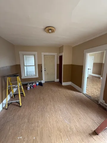 a view of a livingroom with furniture and a window