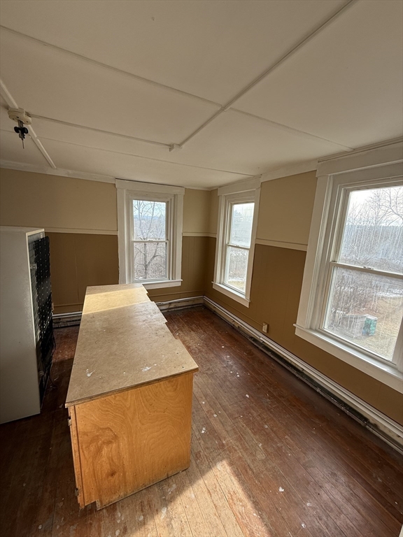 74 Bacon Street, Unit 2 Orange, MA 01364 - Photo 6 of 6 a bed sitting in a spacious bedroom next to a window