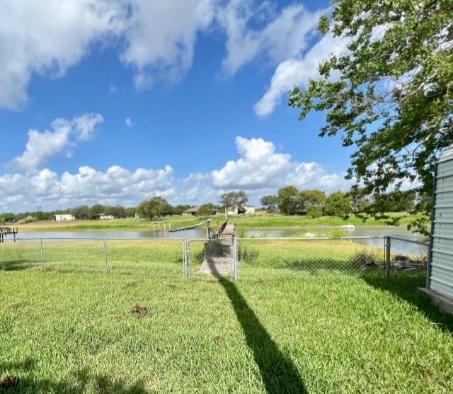 25051 Lake Shore Drive Mathis, TX 78368 - Photo 36 of 40 a view of an ocean with a house in the background