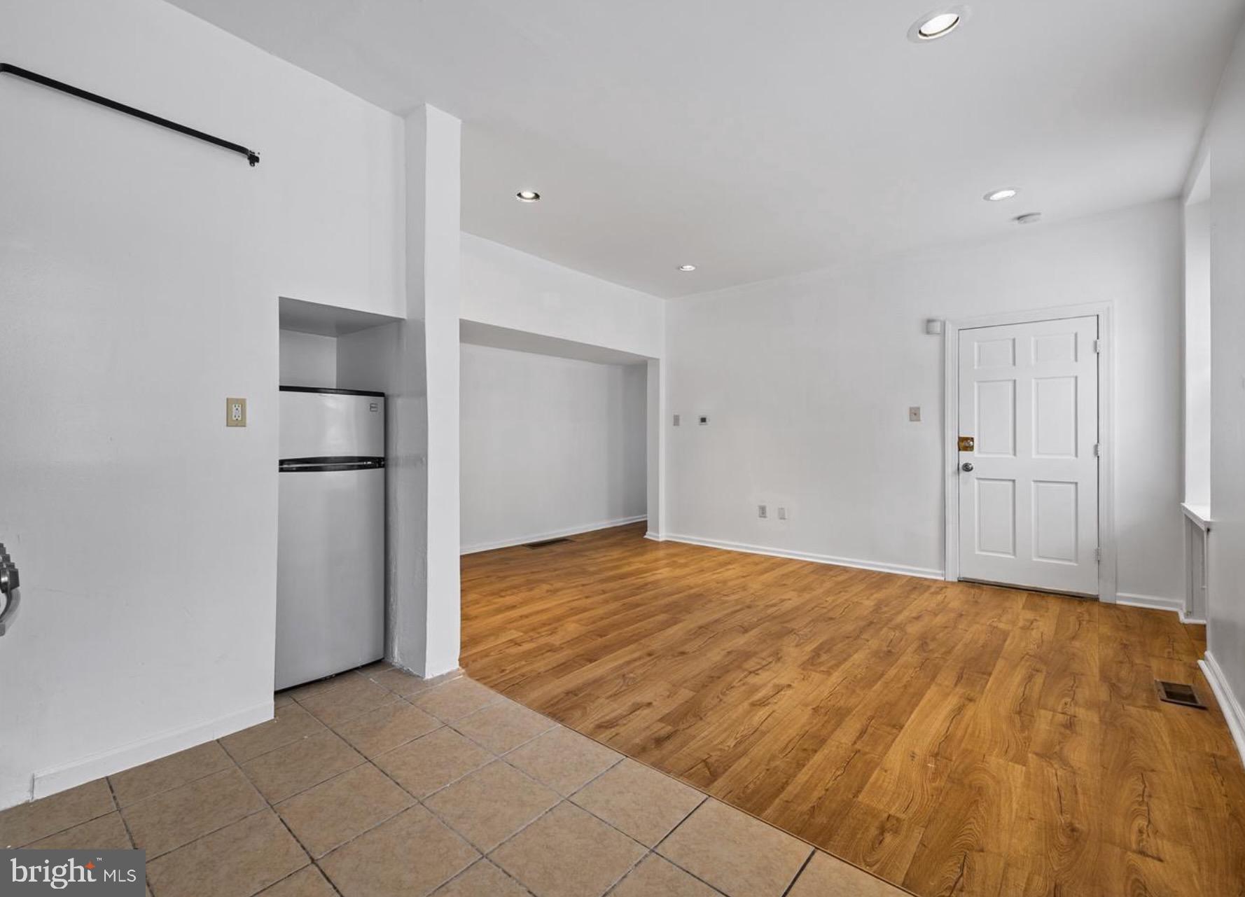 3800 Spring Garden Street, Unit 1 Philadelphia, PA 19104 - Photo 5 of 10 a view of an empty room with wooden floor and cabinets