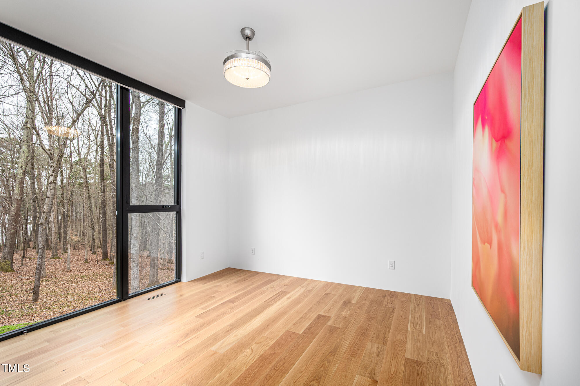 721 Jones Ferry Road Chapel Hill, NC 27516 - Photo 24 of 43 a view of empty room with wooden floor and fan