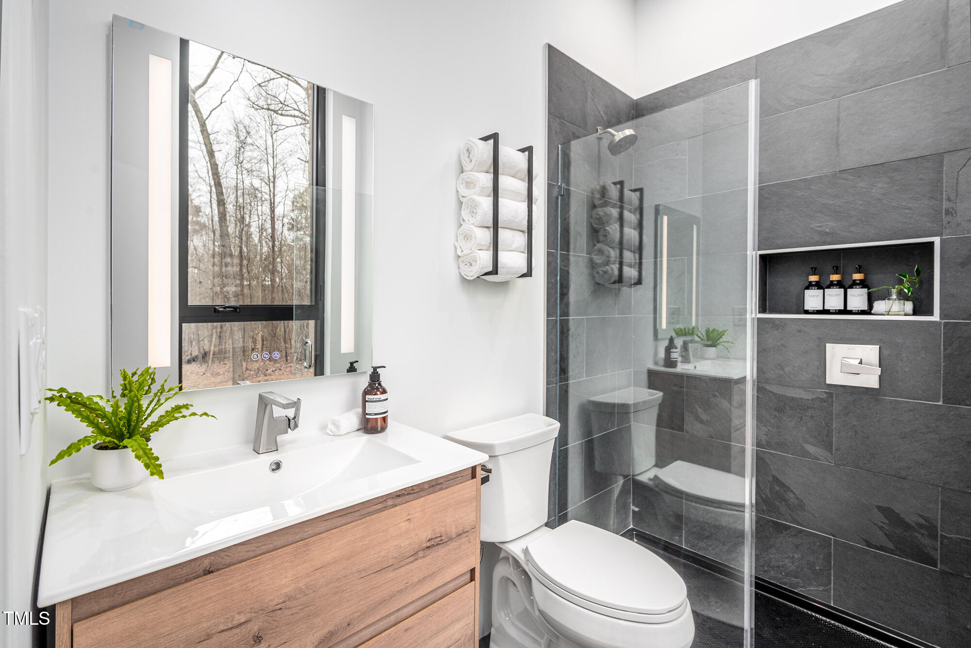 721 Jones Ferry Road Chapel Hill, NC 27516 - Photo 26 of 43 a bathroom with a sink a toilet and shower